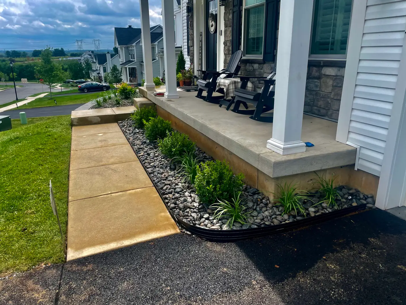 River-rock foundation bed along a front porch