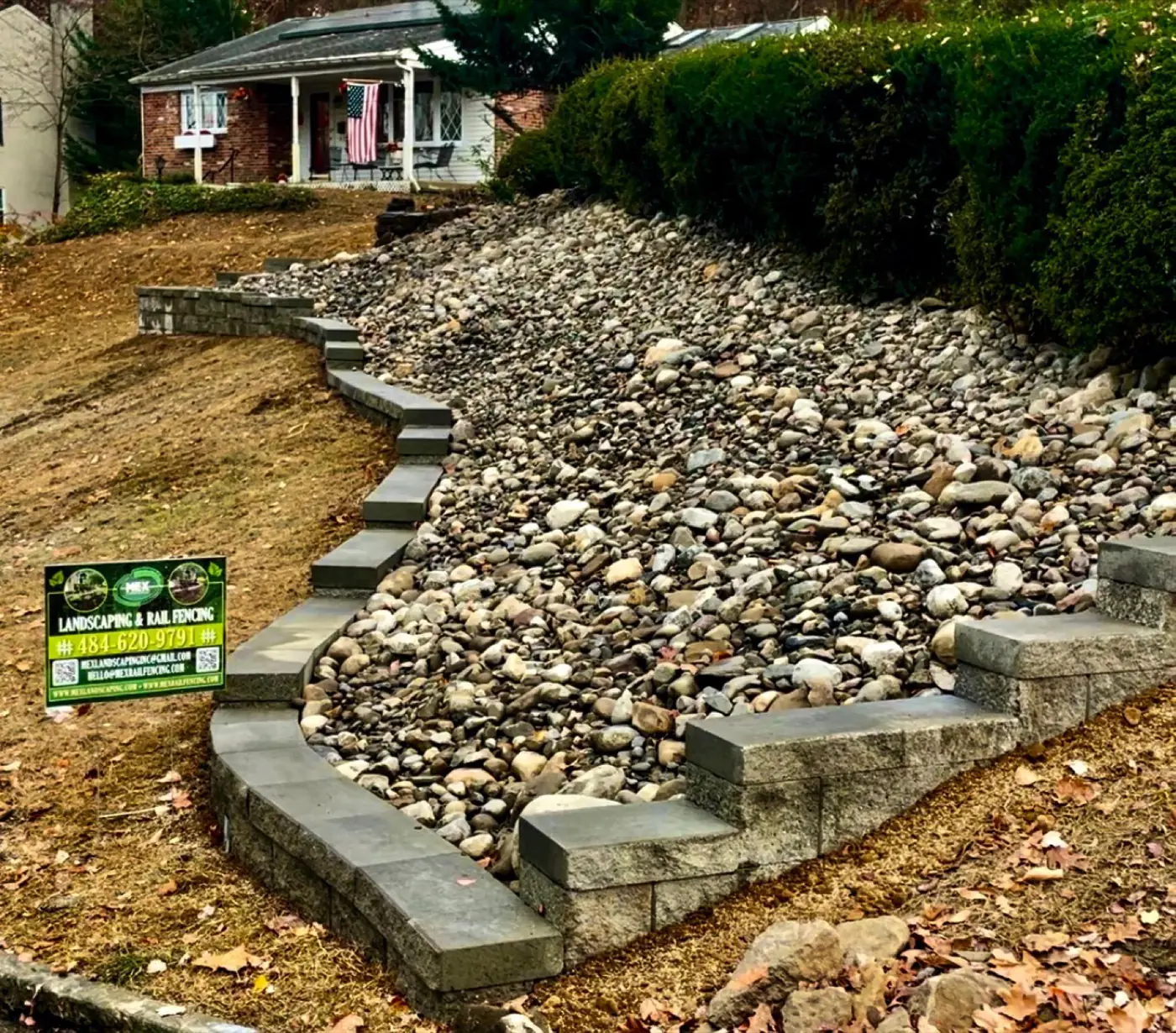 Dry creek drainage channel with natural stone steps crossing it