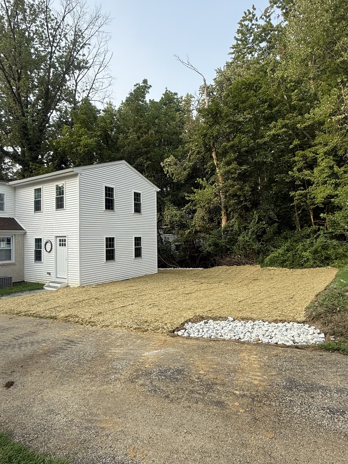 Completed graded and seeded yard with the finished French drain, sloped away from the home