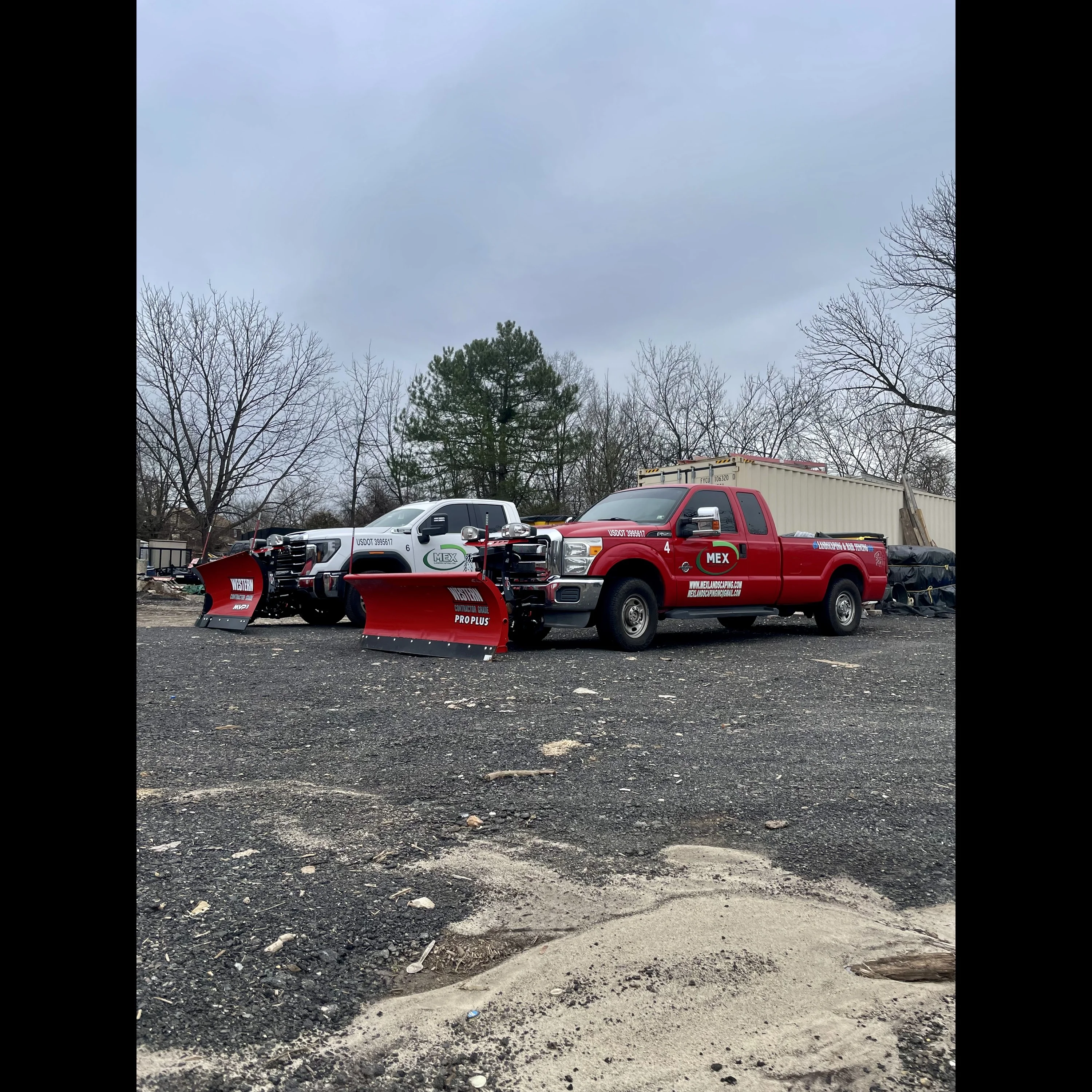 Two MEX plow trucks and snow removal equipment ready for winter service