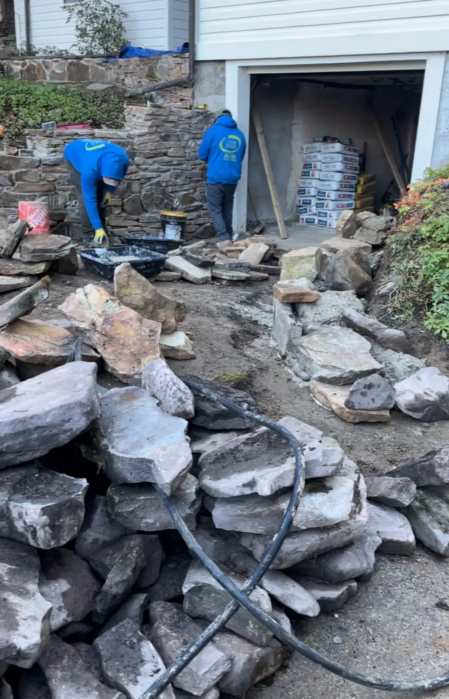 Mex Landscaping masons setting natural fieldstone