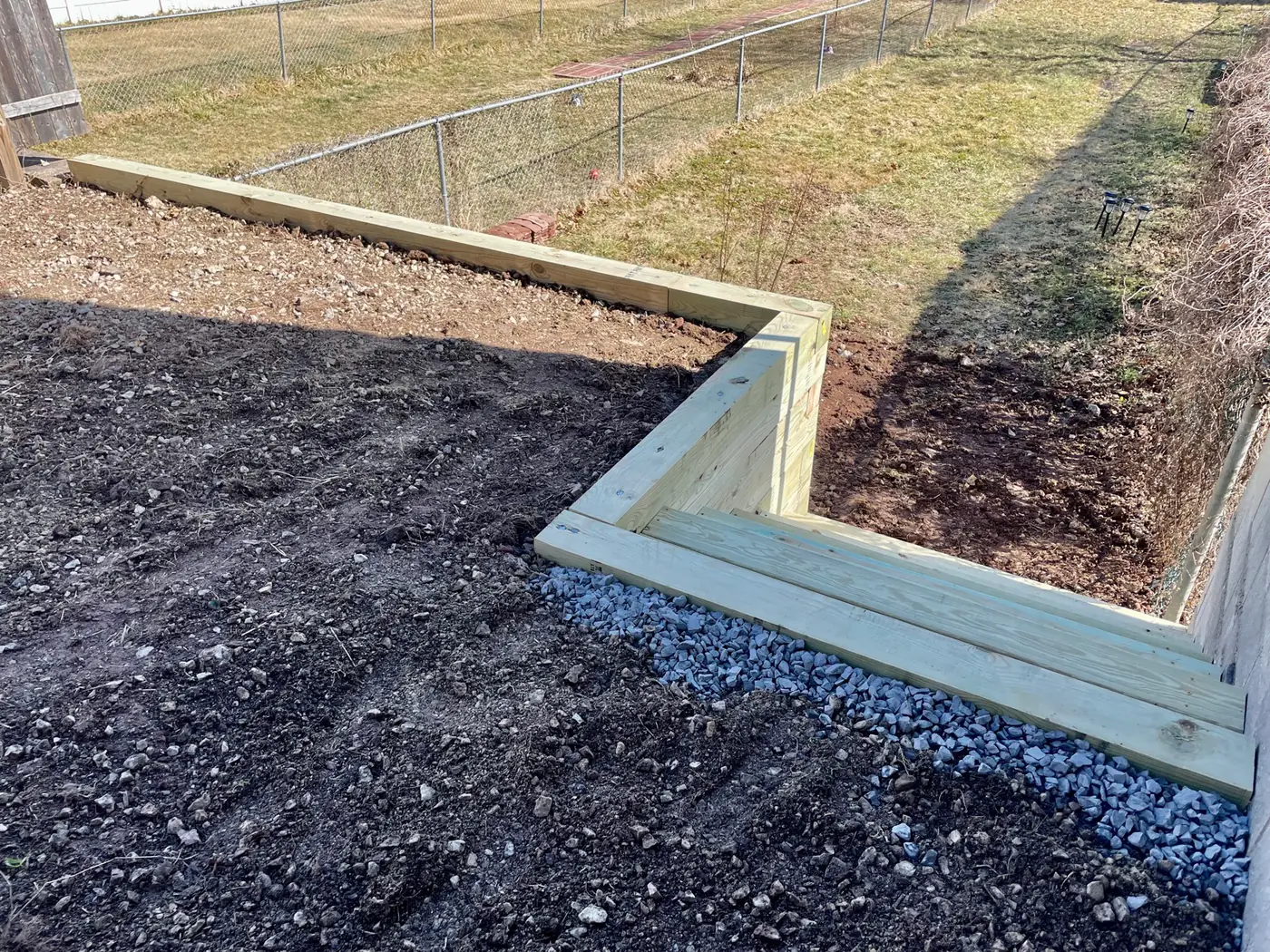 L-shaped timber retaining wall with drainage