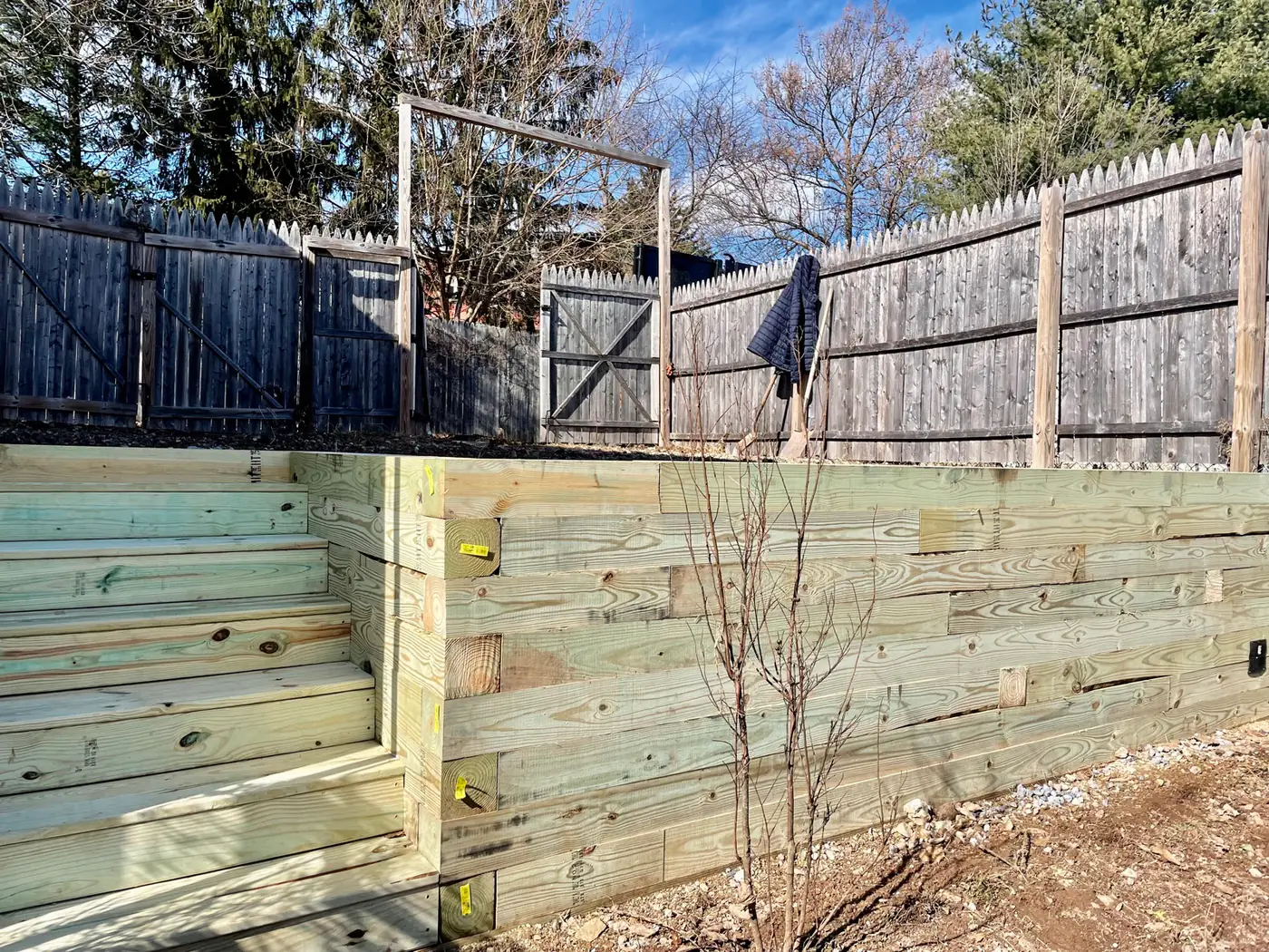 Long timber retaining wall holding a slope
