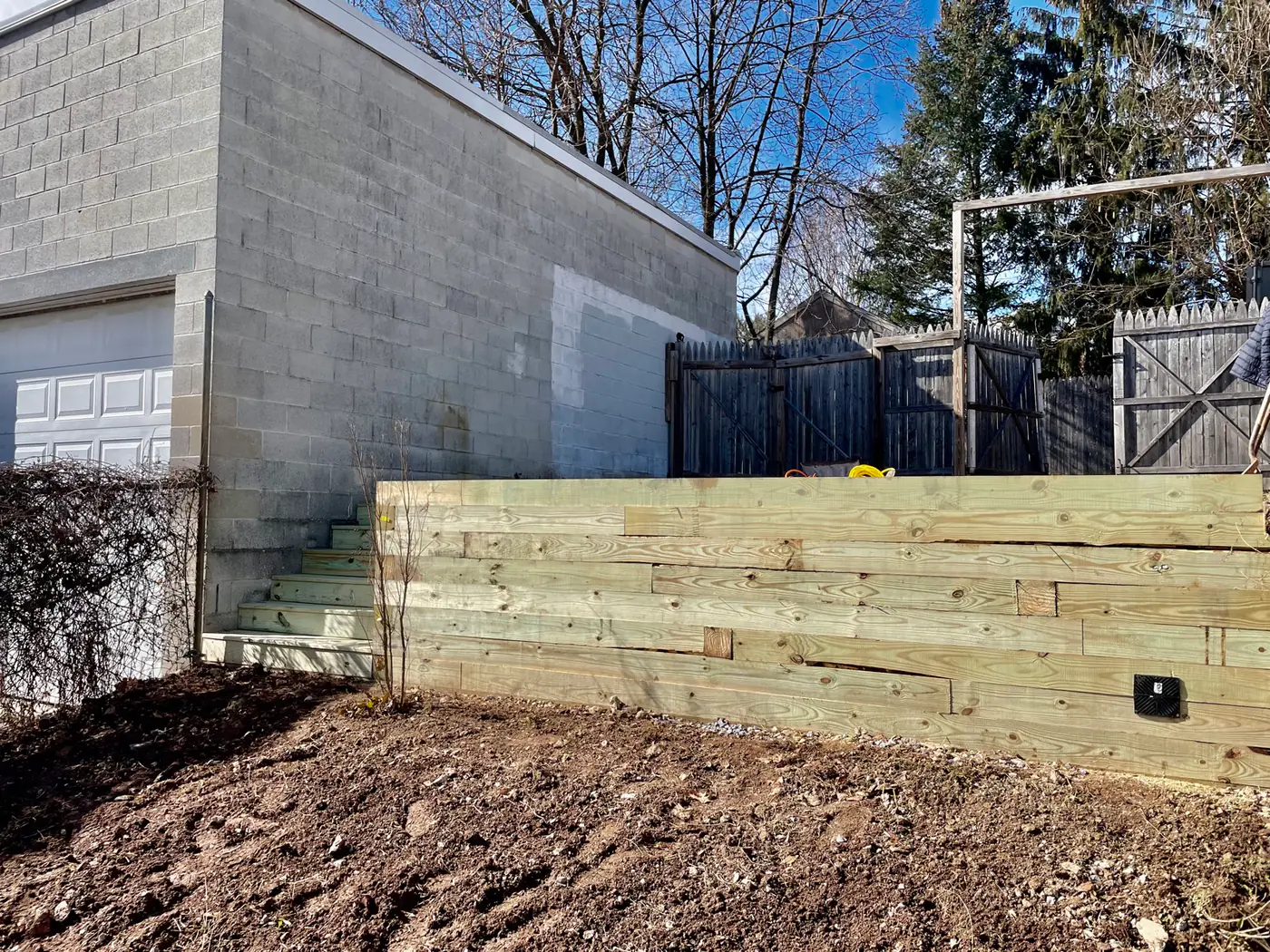 Timber retaining wall with built-in steps